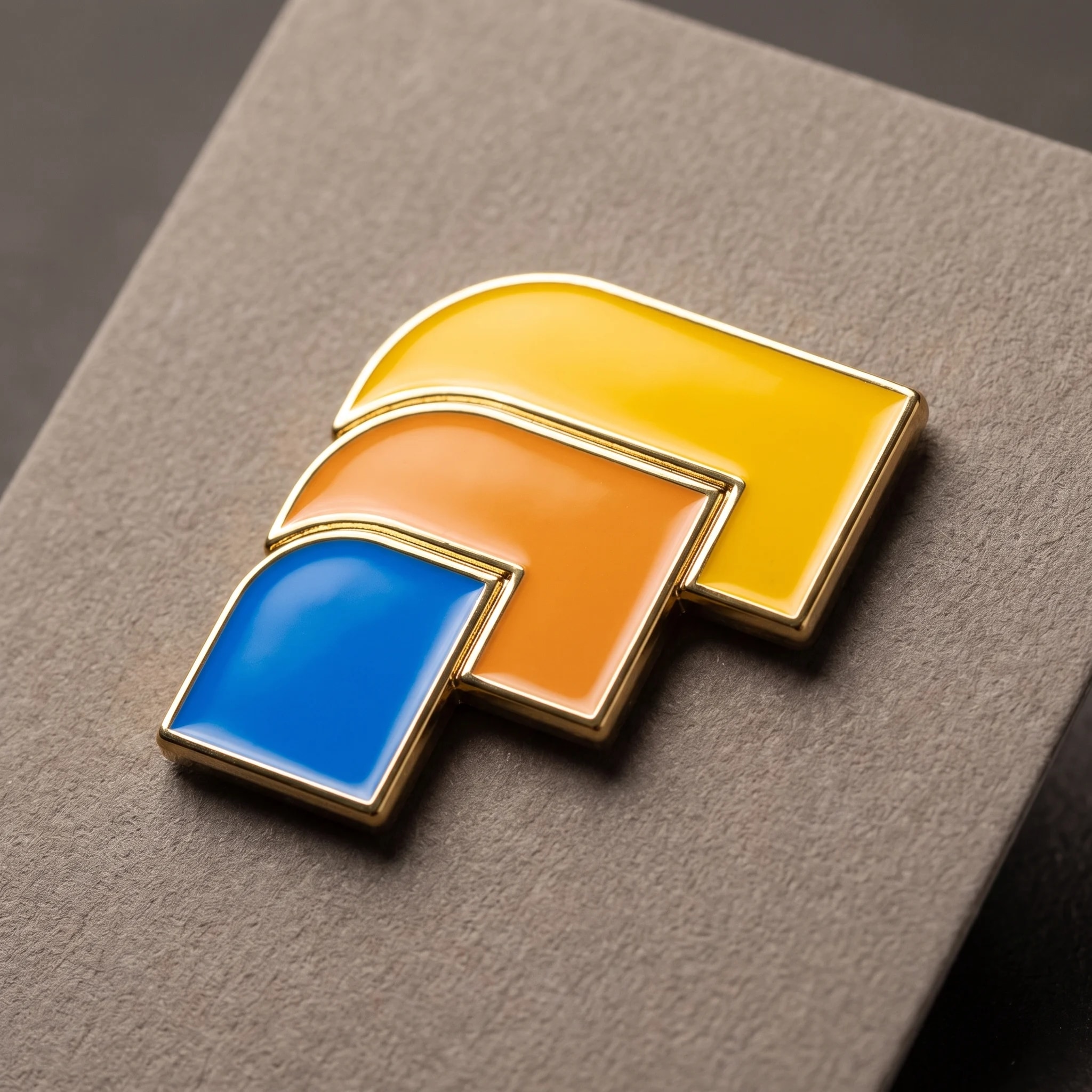 The mark as an object: a hard-enamel pin.